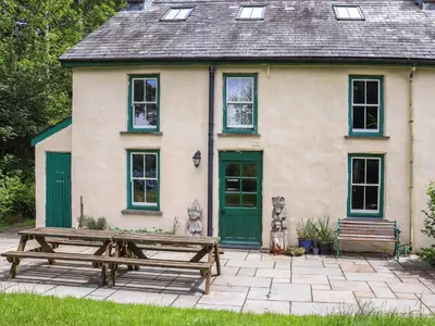 a house with a picnic table in front of it at Farm House - Uk50262 in Llandeilo