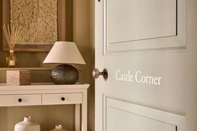 a white door with a table and a lamp at Castle Corner, The Georgian House in Ludlow
