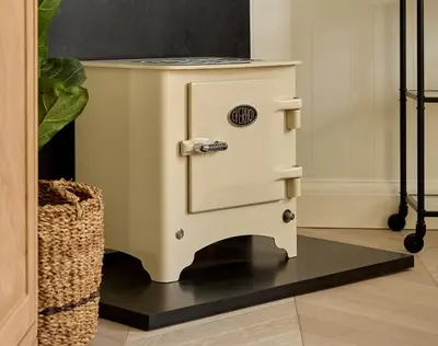 a white stove sitting in a living room at Market View - The Georgian House in Ludlow