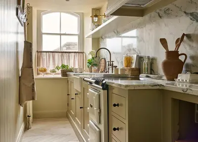 a kitchen with a counter and a sink and a window at Market View - The Georgian House in Ludlow