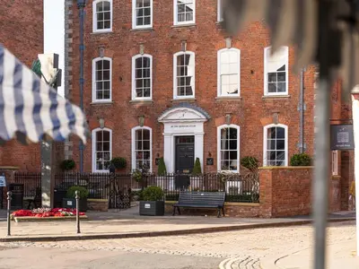 a brick building with a bench in front of it at Stretton Hills Peaks - The Georgian House in Ludlow