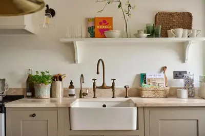 a kitchen sink with two faucets on a counter at Stretton Hills Peaks - The Georgian House in Ludlow