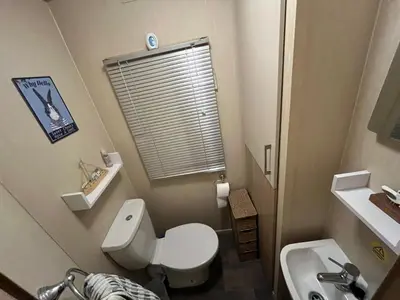 a small bathroom with a toilet and a sink at Gold Plus 3 Bed ABI Summer Breeze Modern Caravan with Sea View Pet Friendly in Aberystwyth