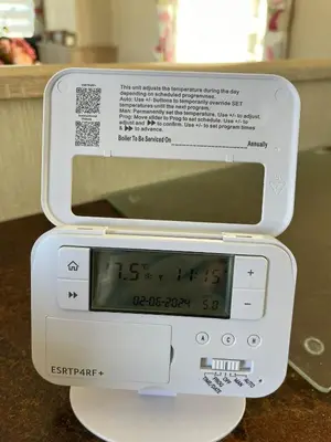 a microwave with a clock on top of it at Gold Plus 3 Bed ABI Summer Breeze Modern Caravan with Sea View Pet Friendly in Aberystwyth