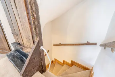 a set of stairs in a house with a wooden door at 2 Bed in Defynnog oc-t32724 in Sennybridge