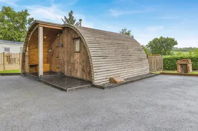a large wooden barn with a porch in a driveway at 1 Bed in Garth oc-h32701 in Garth