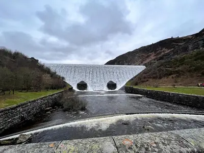 a bridge over a river with a waterfall at 1 Bed in Garth oc-k32702 in Garth