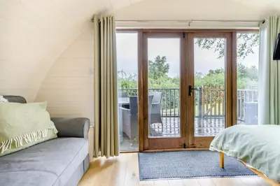 a bedroom with a couch and a sliding glass door at 1 Bed in Garth oc-k32702 in Garth