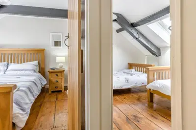 a bedroom with a bed and two beds in it at 2 Bed in Llanon oc-e32781 in Llanon