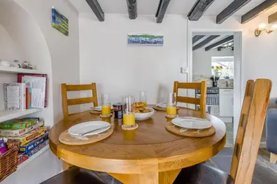 a wooden table with two chairs and a dining room at 2 Bed in Llanon oc-e32781 in Llanon