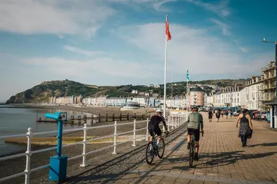 a group of people riding bikes on the beach at 2 Bed in Llanon oc-e32781 in Llanon