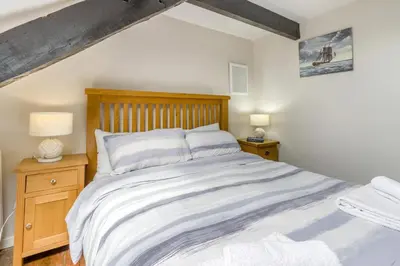 a bedroom with a large bed and two night stands at 2 Bed in Llanon oc-e32781 in Llanon