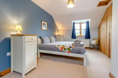 a bedroom with a bed with blue walls and a window at 5 Bed in Devils Bridge oc-t13712 in Devils Bridge
