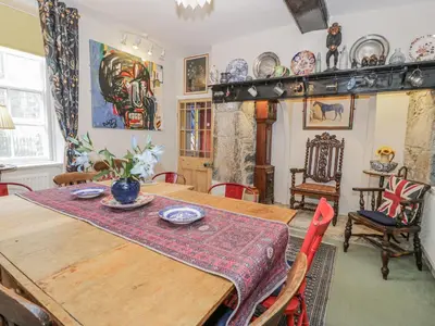 a dining room with a wooden table and chairs at Bryn Dwr in Llangollen