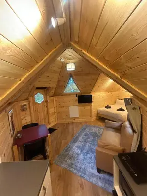 an overhead view of a living room in a tiny house at Clogau Tree House Hot tub &sauna in Penmaenpool
