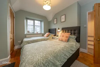a bedroom with two beds and a window at Bodelen in Llanbedr