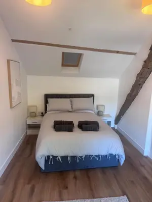 a bedroom with a bed with two pillows on it at 4 Bedroom All En suite Central Townhouse Ideal for Groups in Builth Wells