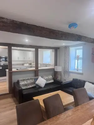 a living room with a couch and a table at 4 Bedroom All En suite Central Townhouse Ideal for Groups in Builth Wells