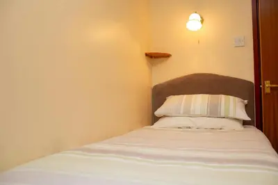 a bedroom with a bed with a pillow on it at The Granary Aberystwyth in Aberystwyth