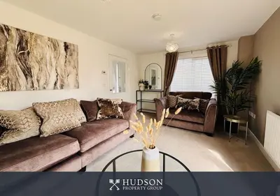 a living room with a couch and a table at 3 Bed Stylish Shrewsbury Home in Shrewsbury