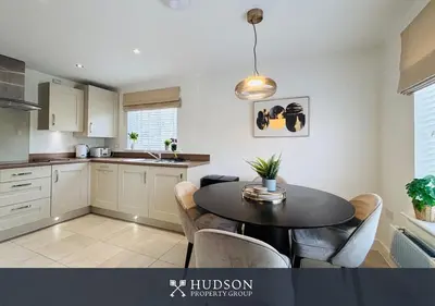 a kitchen with a table and chairs in a room at 3 Bed Stylish Shrewsbury Home in Shrewsbury