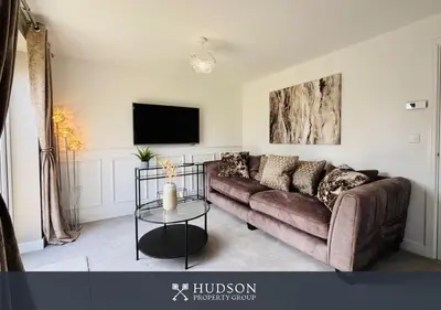 a living room with a couch and a tv at 3 Bed Stylish Shrewsbury Home in Shrewsbury