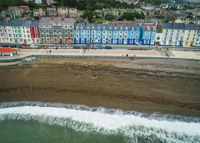 an aerial view of a beach with buildings in the background at The Stable Aberystwyth in Aberystwyth