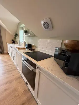 a kitchen with a stove and a counter top at Minafon Loft in Meifod