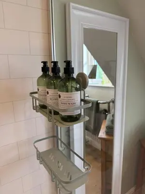 a shelf with three bottles of wine in a bathroom at Minafon Loft in Meifod