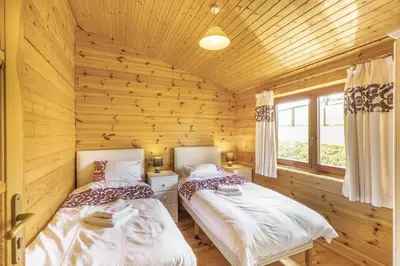 two beds in a room with wooden walls at 2 Bed in Llandinam oc-t32993 in Llandinam