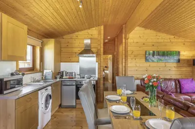 a kitchen and dining room with a table in a cabin at 2 Bed in Llandinam oc-t32993 in Llandinam