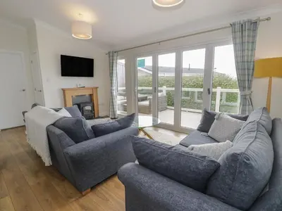 a living room with two couches and a fireplace at Platinum Lodge 503 in Talybont