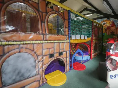 a play room with a toy bus with play equipment at Gold Caravan 203 in Talybont