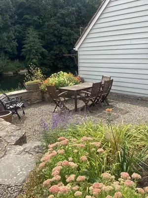 a picnic table and chairs in a garden with flowers at The Studio, spacious riverside property in Ludlow with private parking in Ludlow