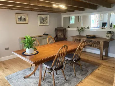 a dining room with a wooden table and chairs at The Studio, spacious riverside property in Ludlow with private parking in Ludlow