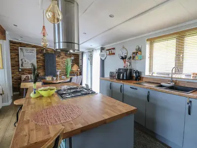 a kitchen with a wooden counter top in a room at Coogee View in New Quay