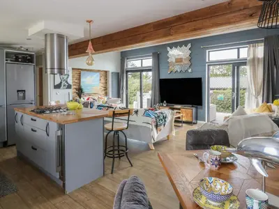 a kitchen and living room with a couch and a table at Coogee View in New Quay