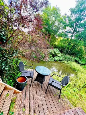 a table and four chairs on a wooden deck at Storeybook cottage in Oswestry