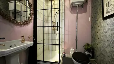 a bathroom with a shower and a toilet and a sink at Tyddyn Eglwys in Talsarnau