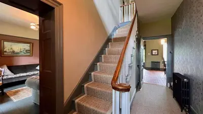 a staircase in a home with a stair case at Tyddyn Eglwys in Talsarnau