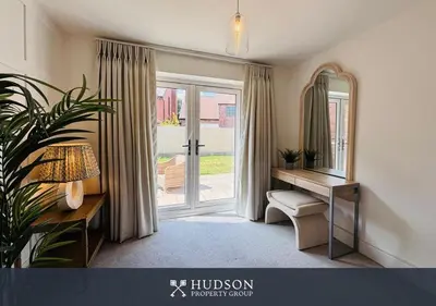 a room with a mirror and a desk and a door at 3 Bedroom Home Near Shrewsbury