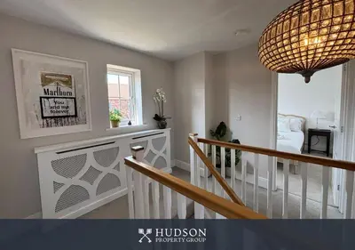a room with a staircase and a chandelier at 3 Bedroom Home Near Shrewsbury