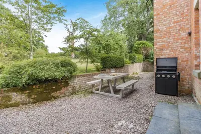 a backyard with a picnic table and a stove at 3 Bed in Cyfronydd oc-e32742 in Llanfair Caereinion