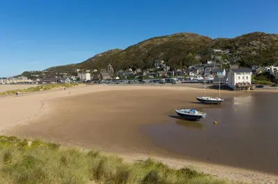 two boats sitting on the sand on a beach at 3 Bed in Cyfronydd oc-e32742 in Llanfair Caereinion