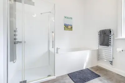 a white bathroom with a glass shower stall at 3 Bed in Cyfronydd oc-e32742 in Llanfair Caereinion