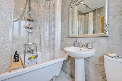 a bathroom with a sink and a tub and a toilet at 3 Bed in Forden oc-c30173 in Forden