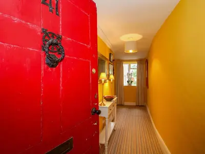 a red door in a hallway with a red wall at 41 High Street in Bishops Castle
