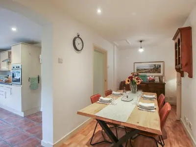 a dining room and kitchen with a table and chairs at 2 Aqueduct Cottages in Wrexham