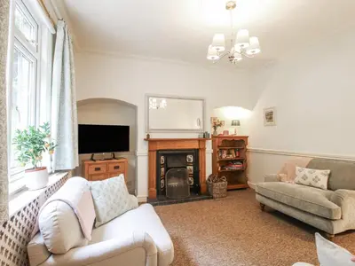 a living room with a couch and a fireplace at 2 Aqueduct Cottages in Wrexham