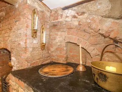 a stone bathroom with a tub and a sink at Raven Lane Retreat in Ludlow